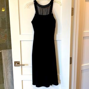 Sophisticated black dress with a classic aline fit and midi length.